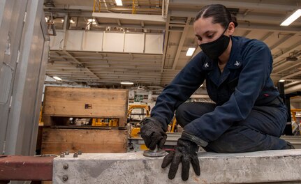 PORTSMOUTH, Va. (May 12, 2021) Aviation Support Equipment Technician 3rd Class Valerie Avila, from Phelan, California, checks the material condition of a tow bar bolt in the hangar bay of the Nimitz-class aircraft carrier USS Harry S. Truman (CVN 75). Truman departed Norfolk Naval Shipyard after completing a 10-month regularly scheduled extended carrier incremental availability. During the availability, the ship underwent maintenance, repair and inspection of various equipment to include engineering, combat systems, and nuclear propulsion. (U.S. Navy photo by Mass Communications Seaman Christopher Suarez)