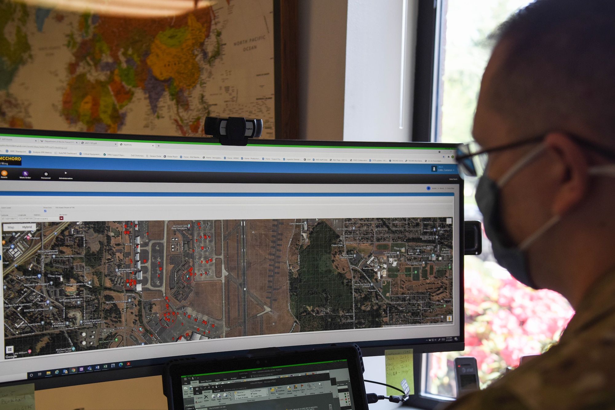 U.S. Air Force Master Sgt. Cameron Cofer, 62nd Maintenance Squadron aerospace ground equipment flight chief, looks at a map showing the location of AGE equipment around Joint Base Lewis-McChord, Washington, May 13, 2021. The AGE career field recently started installing GPS tracking devices on some of their mobile equipment to ensure accountability. (U.S. Air Force photo by Senior Airman Mikayla Heineck)