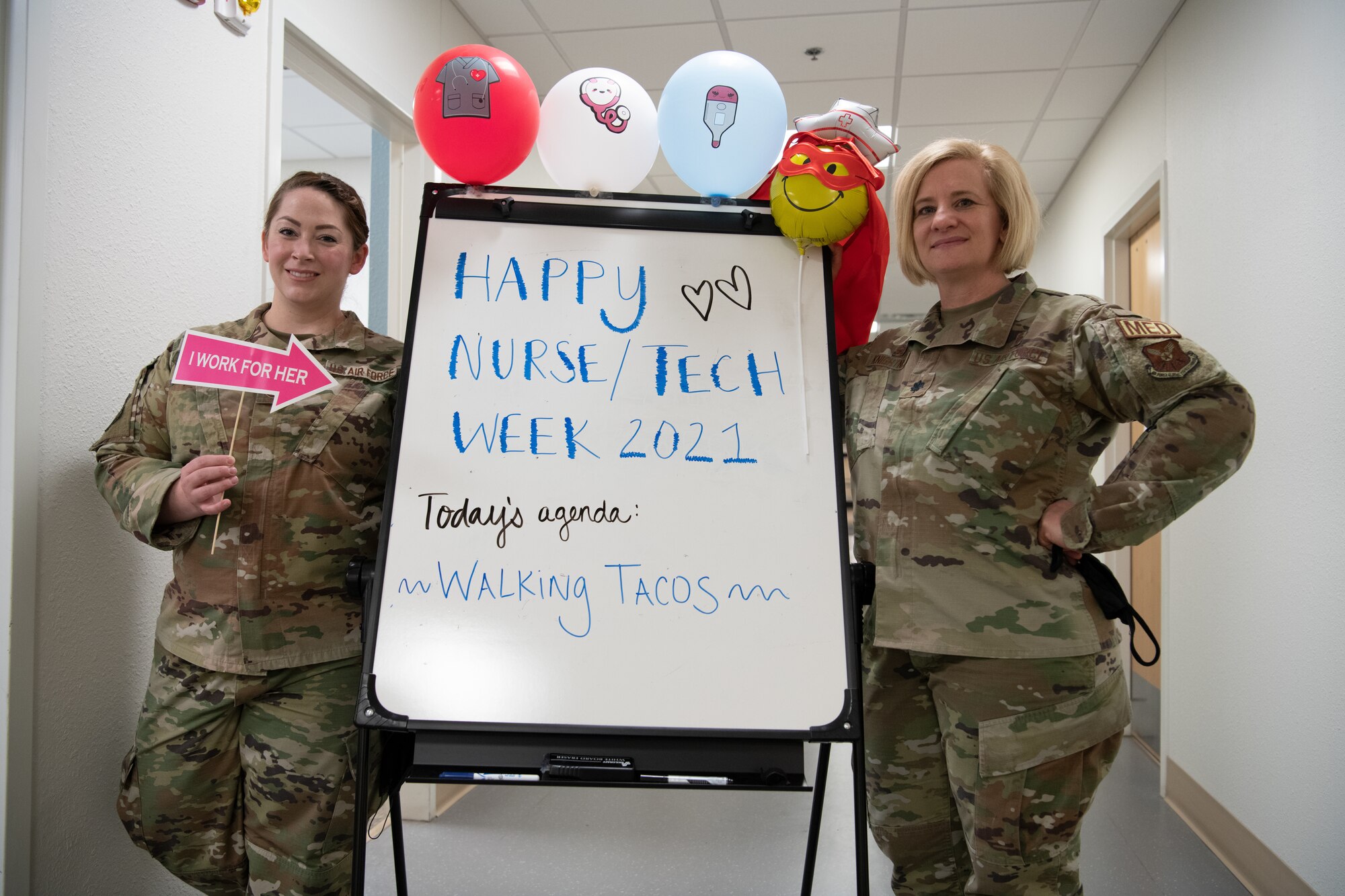Tech. Sgt. Kylle Hannan, NCOIC of education and training, 90th Medical Group, and Lt. Col. Erin Knightner, 90th Operational Medical Readiness Squadron commander, highlight a whiteboard celebrating National Nurses Week on F.E. Warren Air Force Base, Wyoming, May 6, 2021. The 90 MDG celebrates National Nurses Week to recognize medical staff for their efforts. (U.S. Air Force photo by Airman 1st Class Charles Munoz)