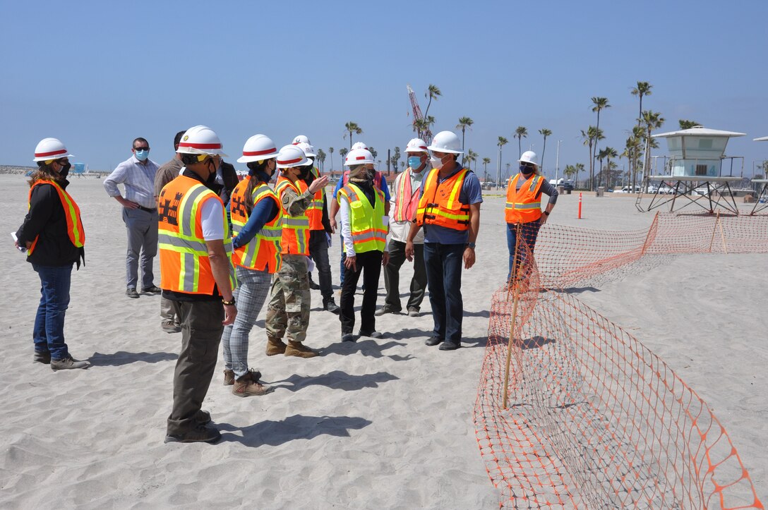 U.S. Army Corps of Engineers Los Angeles District commander Col. Julie Balten speaks with members of her team, city officials and contractors, April 12, on Oceanside Beach, California. The annual maintenance dredging of Oceanside Harbor is contracted and supervised by the U.S. Army Corps of Engineers Los Angeles District.