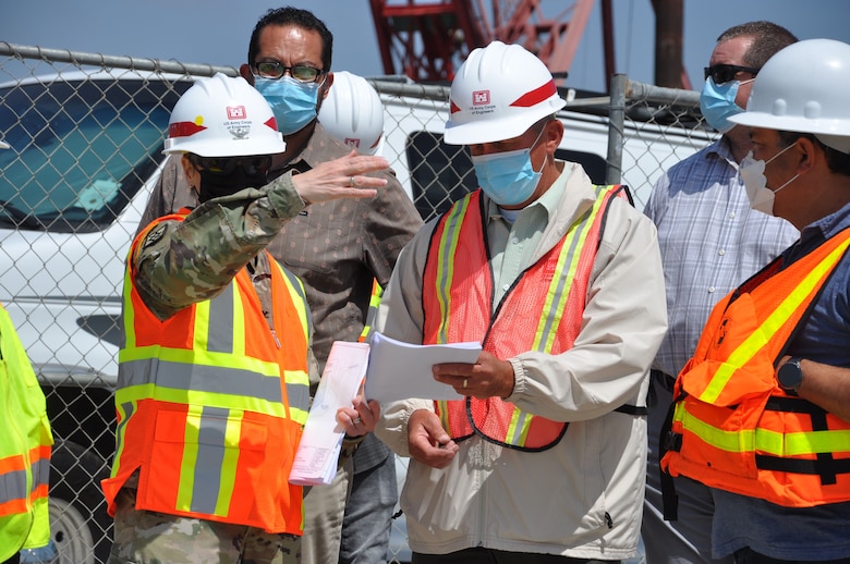 U.S. Army Corps of Engineers Los Angeles District commander Col. Julie Balten asks a contractor about the construction zone at the mouth of Oceanside Harbor, April 12. Sand dredged from the harbor will be piped to a section of Oceanside Beach, California. The annual maintenance dredging of Oceanside Harbor is contracted and supervised by the U.S. Army Corps of Engineers Los Angeles District.