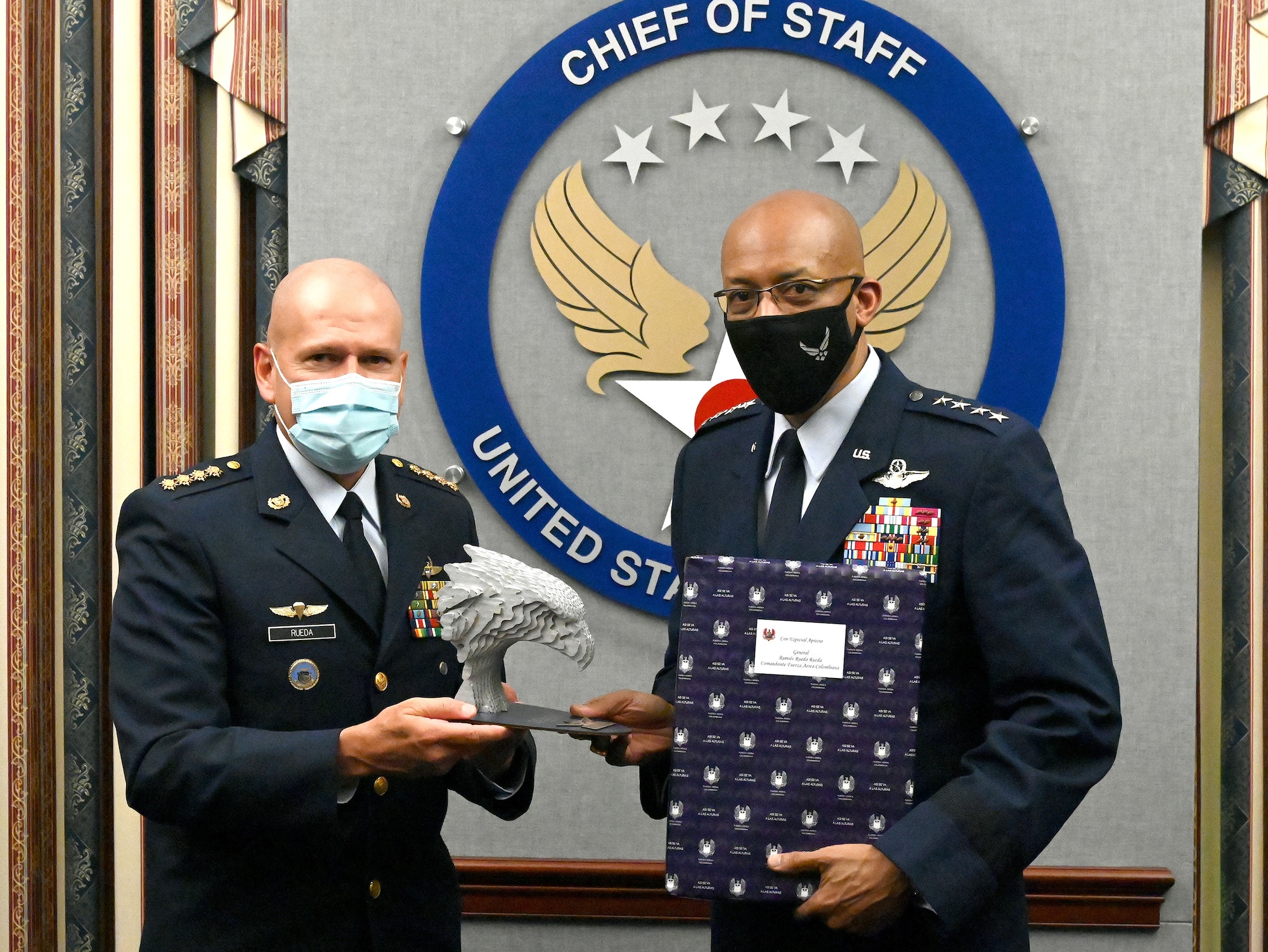 Chief of Staff of the Air Force Gen. Charles Q. Brown Jr. (right) and Gen. Ramses Rueda Rueda, commander of the Colombian air force exchange gifts