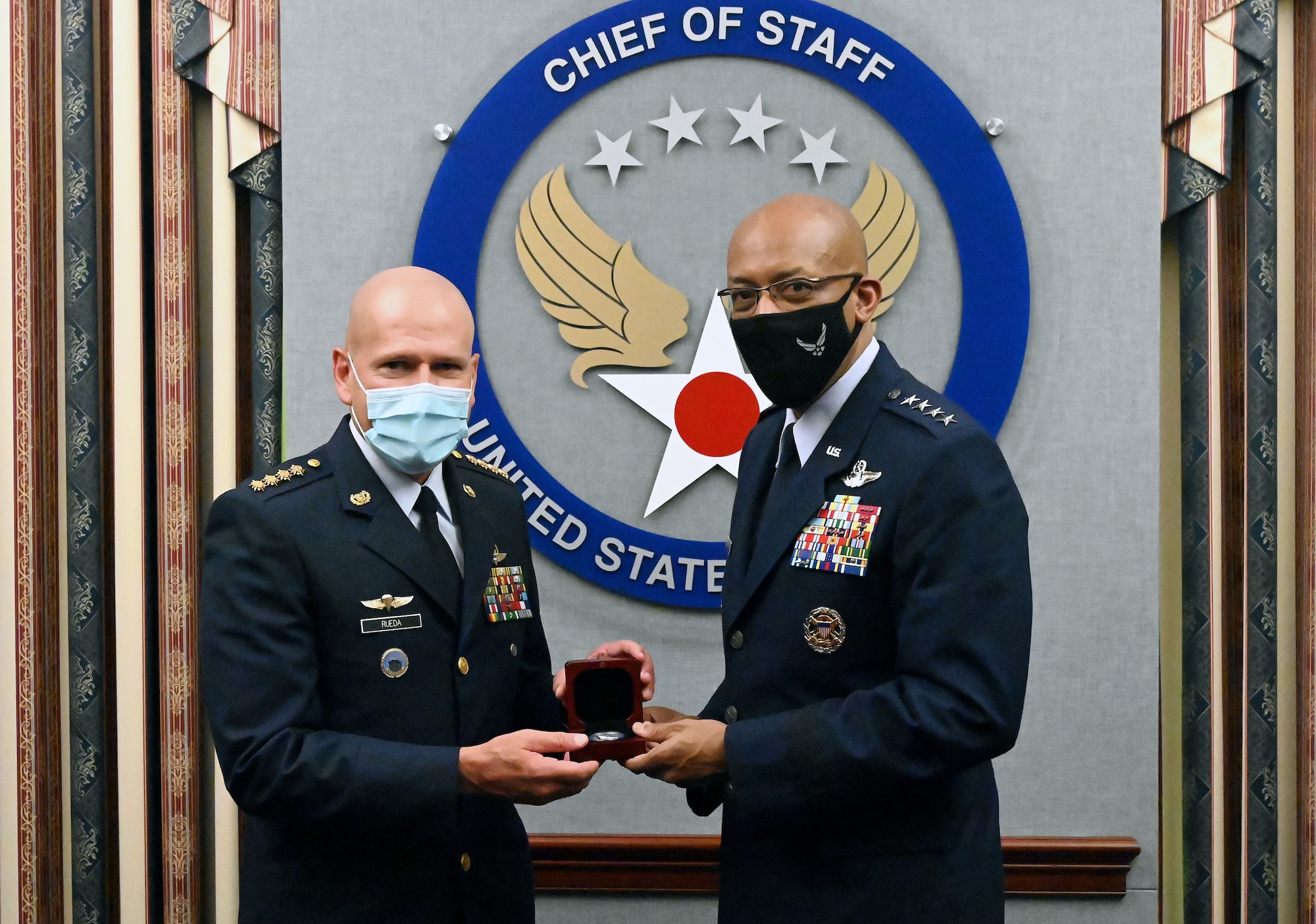 Chief of Staff of the Air Force Gen. Charles Q. Brown Jr. (right) and Gen. Ramses Rueda Rueda, commander of the Colombian air force exchange gifts after a meeting