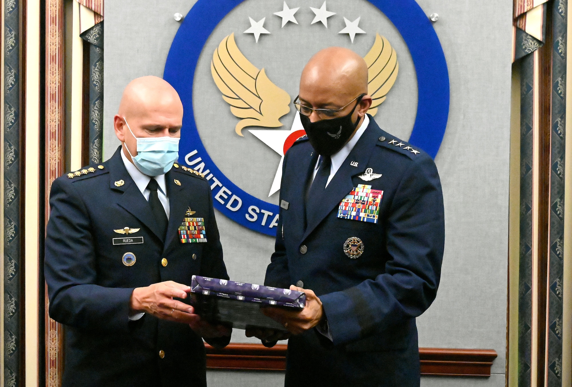 Chief of Staff of the Air Force Gen. Charles Q. Brown Jr. (right) and Gen. Ramses Rueda Rueda, commander of the Colombian air force exchange gifts