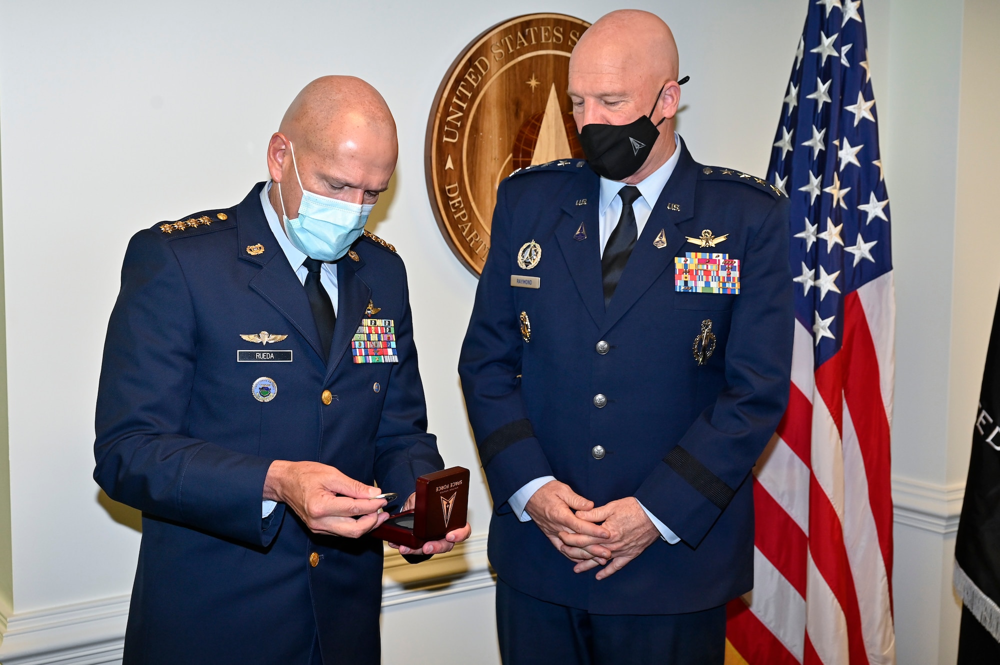 Gen. Ramses Rueda Rueda, commander of the Colombian air force, opens a gift from Chief of Space Operations Gen. John W. Raymond