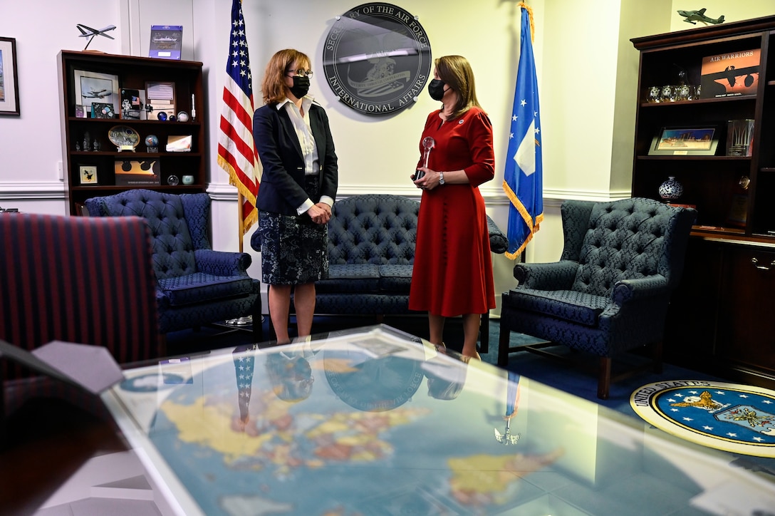 Kelli Seybolt, left, deputy undersecretary of the Air Force for international affairs, speaks with Robyn Disselkoen-Russell after presenting her with the Air Force International Affairs Excellence Award during a ceremony at the Pentagon, Arlington, Va., April 29, 2021. Disselkoen-Russell won the 2019 senior civilian category for her work as the deputy chief of international affairs, Directorate of Strategy Plans and Programs, Pacific Air Forces. (U.S. Air Force photo by Eric Dietrich)