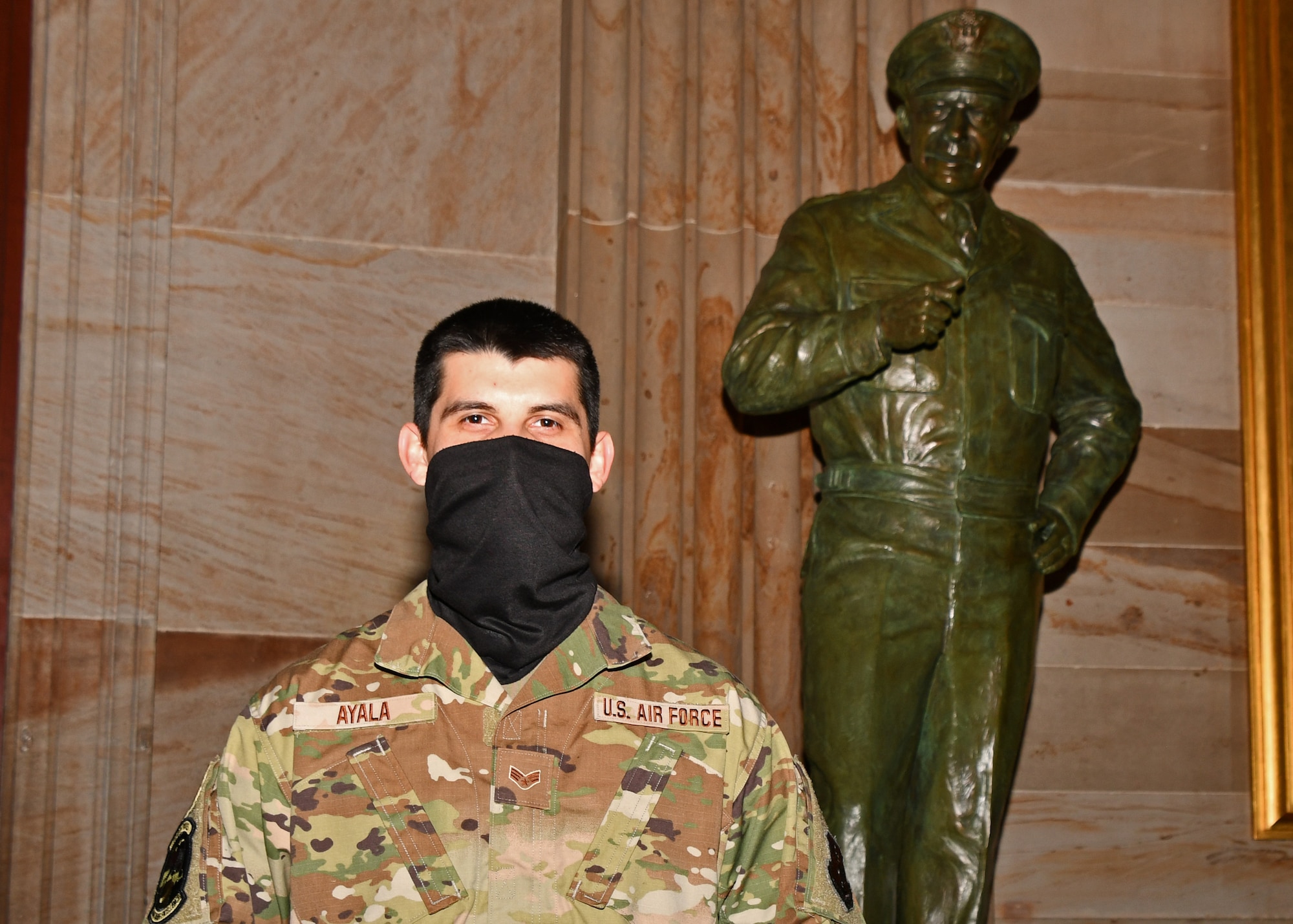 U.S. Air Force Senior Airman Dorian Ayala, an avionics test station technician with the 104th Fighter Wing Maintenance Squadron, poses for a photo in front of the Dwight D. Eisenhower statue in the United States Capitol building in Washington, D.C., May 13, 2021. The National Guard has been requested to continue supporting federal law enforcement agencies with security, communications, medical evacuation, logistics and safety support to state, district and federal agencies through mid-May. (U.S. Air National Guard photo by Staff Sgt. Hanna Smith)