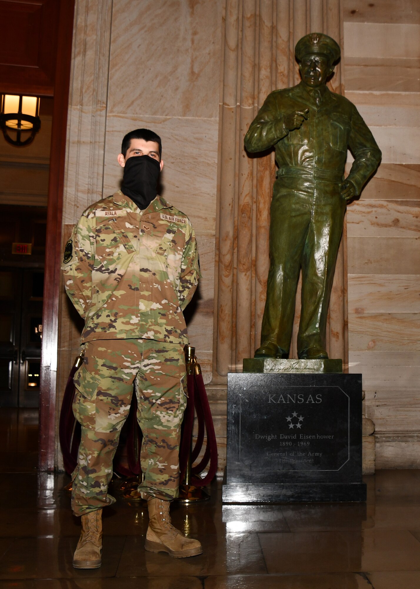 U.S. Air Force Senior Airman Dorian Ayala, an avionics test station technician with the 104th Fighter Wing Maintenance Squadron, poses for a photo in front of the Dwight D. Eisenhower statue in the United States Capitol building in Washington, D.C., May 13, 2021. The National Guard has been requested to continue supporting federal law enforcement agencies with security, communications, medical evacuation, logistics and safety support to state, district and federal agencies through mid-May. (U.S. Air National Guard photo by Staff Sgt. Hanna Smith)