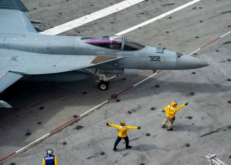 An F/A-18E Super Hornet, attached to the "Blue Blasters" of Strike Fighter Squadron (VFA) 34, taxis on the flight deck of the Nimitz-class aircraft carrier USS Harry S. Truman (CVN 75) during carrier qualifications after completing an extended incremental availability.