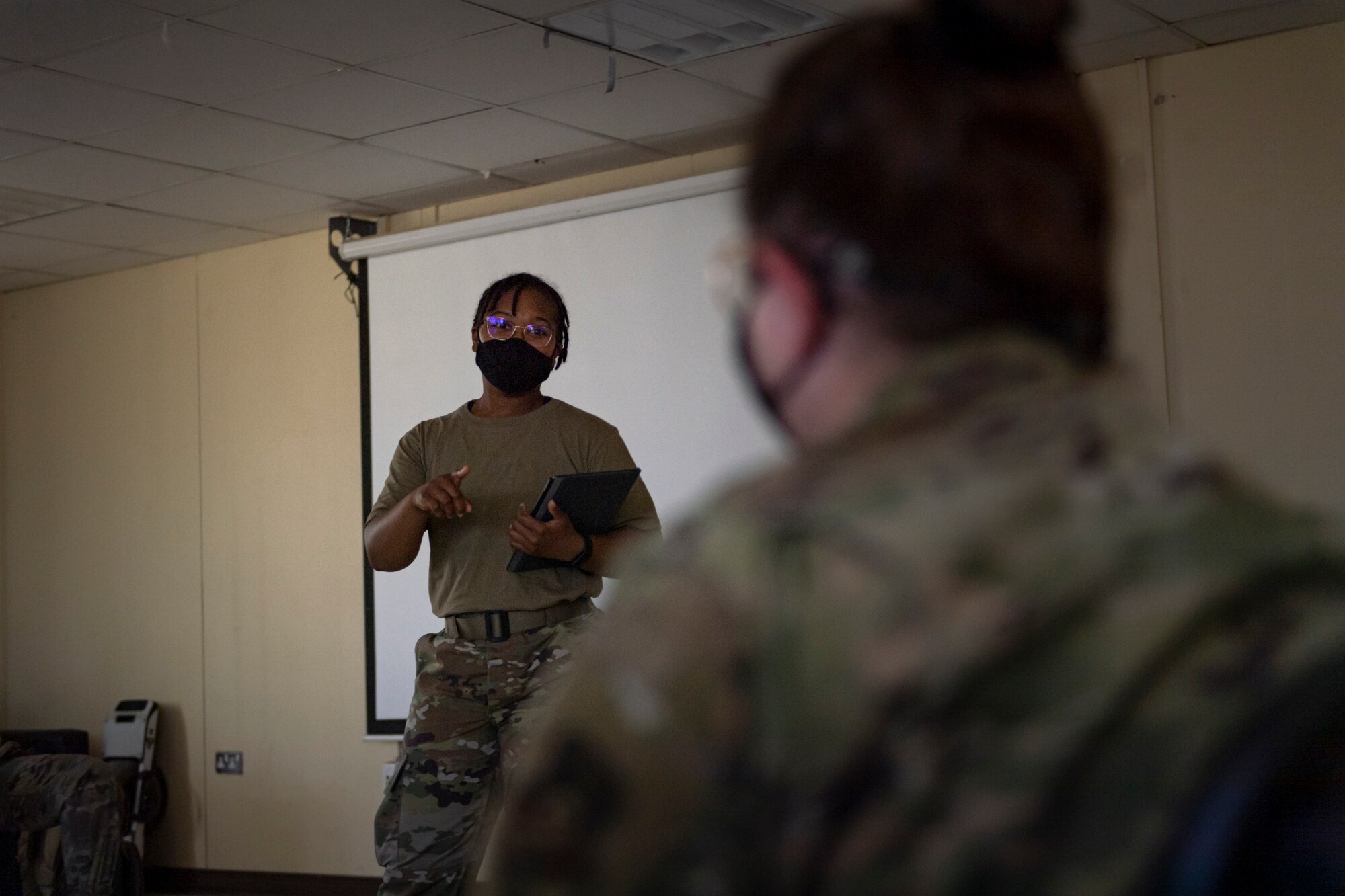 A photo of an Airman speaking to another Airman