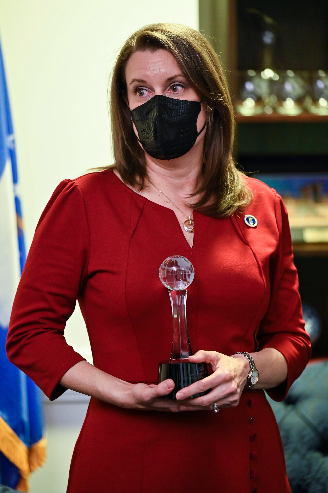 Robyn Disselkoen-Russell holds her award after being presented the Air Force International Affairs Excellence Award during a ceremony at the Pentagon, Arlington, Va., April 29, 2021. Disselkoen-Russell won the 2019 senior civilian category for her work as the deputy chief of international affairs, Directorate of Strategy Plans and Programs, Pacific Air Forces. (U.S. Air Force photo by Eric Dietrich)