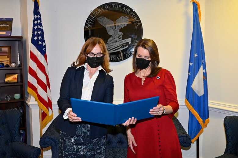 Kelli Seybolt, left, deputy undersecretary of the Air Force for international affairs, presents the Air Force International Affairs Excellence Award to Robyn Disselkoen-Russell during a ceremony at the Pentagon, Arlington, Va., April 29, 2021. Disselkoen-Russell won the 2019 senior civilian category for her work as the deputy chief of international affairs, Directorate of Strategy Plans and Programs, Pacific Air Forces. (U.S. Air Force photo by Eric Dietrich)