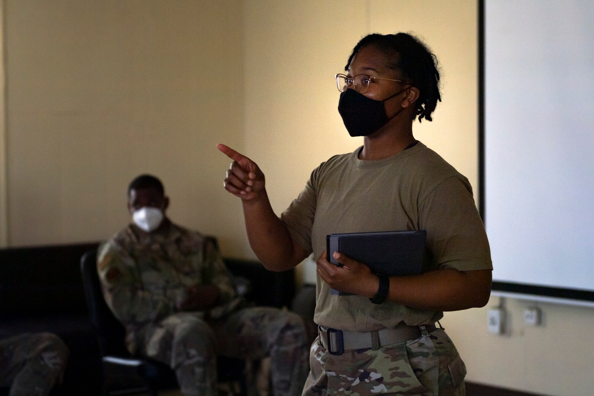 A photo of an Airman speaking to a group