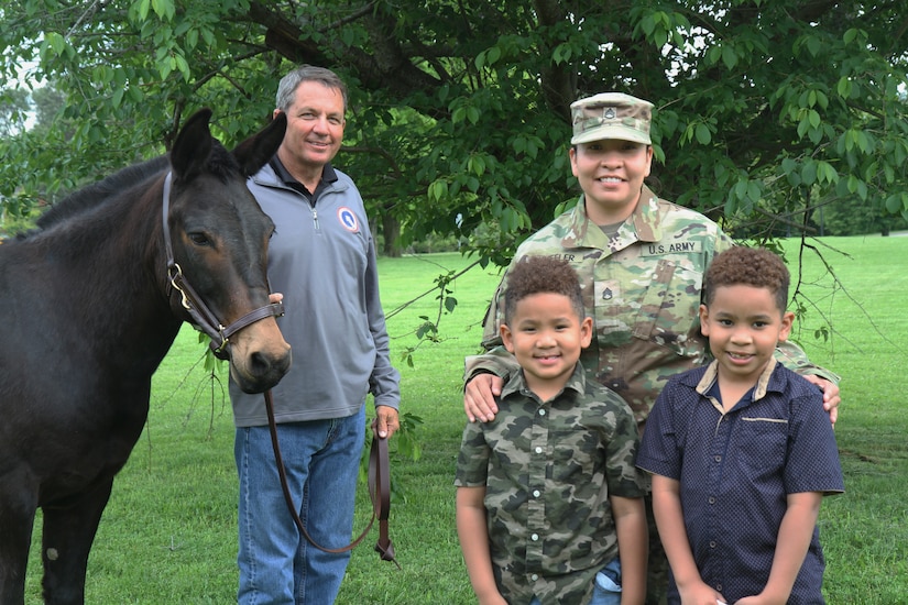 soldier with family and unit mascot blackjack the mule