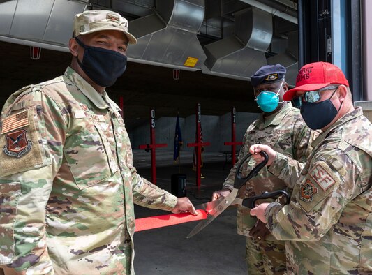 From the left, Col. Phelemon Williams, 436th Mission Support Group commander, Lt. Col. Schneider Rislin, 436th Security Forces Squadron commander, and Tech. Sgt. Joseph Haller, 436th SFS noncommissioned officer in charge of Combat Arms Training and Maintenance, cut a ribbon to reopen the CATM firing range on Dover Air Force Base, Delaware, May 12, 2021. The range closed in June 2020 for extended inspection and improvements and is now open for regular operations. (U.S. Air Force photo by Airman 1st Class Cydney Lee)