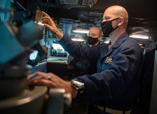 PORTSMOUTH, Va. (May 12, 2021) Lt. j.g. John Rooney, right, from Houston, uses an automated identification system to verify the navigation systems on the bridge of the Nimitz-class aircraft carrier USS Harry S. Truman (CVN 75). Truman departed Norfolk Naval Shipyard after completing a 10-month regularly scheduled extended carrier incremental availability. During the availability, the ship underwent maintenance, repair and inspection of various equipment to include engineering, combat systems, aircraft support, and nuclear propulsion.  (U.S. Navy photo by Mass Communication Specialist Seaman Tyler Cardoza)