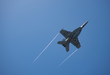 An F/A-18E Super Hornet, attached to the "Blue Blasters" of Strike Fighter Squadron (VFA) 34, flies over the Nimitz-class aircraft carrier USS Harry S. Truman (CVN 75) during carrier qualifications after completing an extended incremental availability.