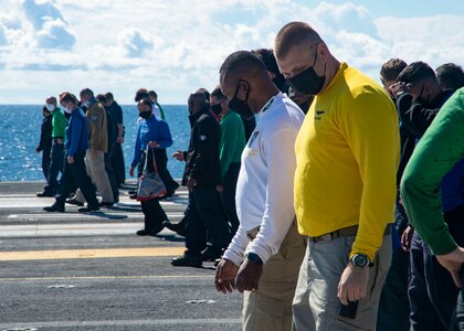 Sailors search for foreign object debris (FOD) during a FOD walk-down on the flight deck of the Nimitz-class aircraft carrier USS Harry S. Truman (CVN 75) during sea trials after completing an extended carrier incremental availability.