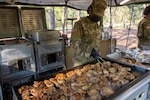 New York Army National Guard Spc. Fatima S. Edwards, assigned to Headquarters and Headquarters Company, 101st Expeditionary Signal Battalion, cooks chicken during training for the next Philip A. Connelly Competition at Joint Base McGuire-Dix-Lakehurst, N.J., May 15, 2021. The competition provides recognition for excellence in the preparation and serving of food in Army troop dining facilities and field kitchens.