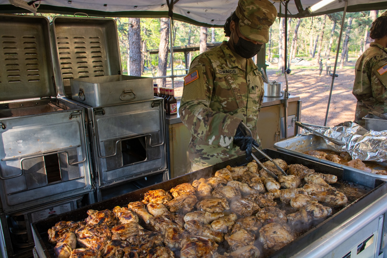 New York Army National Guard Spc. Fatima S. Edwards, assigned to Headquarters and Headquarters Company, 101st Expeditionary Signal Battalion, cooks chicken during training for the next Philip A. Connelly Competition at Joint Base McGuire-Dix-Lakehurst, N.J., May 15, 2021. The competition provides recognition for excellence in the preparation and serving of food in Army troop dining facilities and field kitchens.