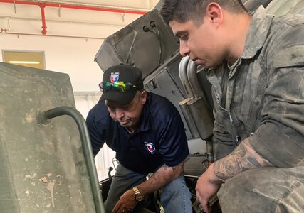 Cliff Pass, a U.S. Army Tank-automotive and Armaments Command Logistics Assistance Representative assigned to the 405th Army Field Support Brigade’s Army Field Support Battalion-Germany, works on a M270A1 Multiple Launch Rocket System’s power take off and clutch with Sgt. Jorge Davila, a tracked vehicle repair technician from A Battery, 1st Battalion, 6th Field Artillery Regiment, 41st Field Artillery Brigade.