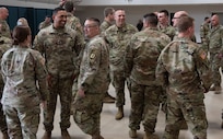 Vermont National Guard Soldiers assigned to Task Force Mansfield socialize after the end of a sendoff ceremony at Camp Johnson, Vermont, May 18, 2021. The task force is slated to deploy to the U.S. European Command area of responsibility to assist with peacekeeping operations. (U.S. Army National Guard photo by Don Branum)