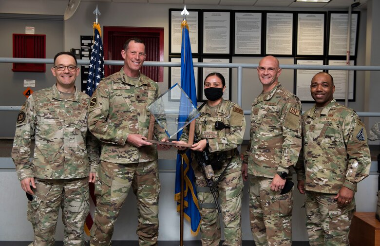 Members of security forces on Peterson Air Force Base posing with the award
