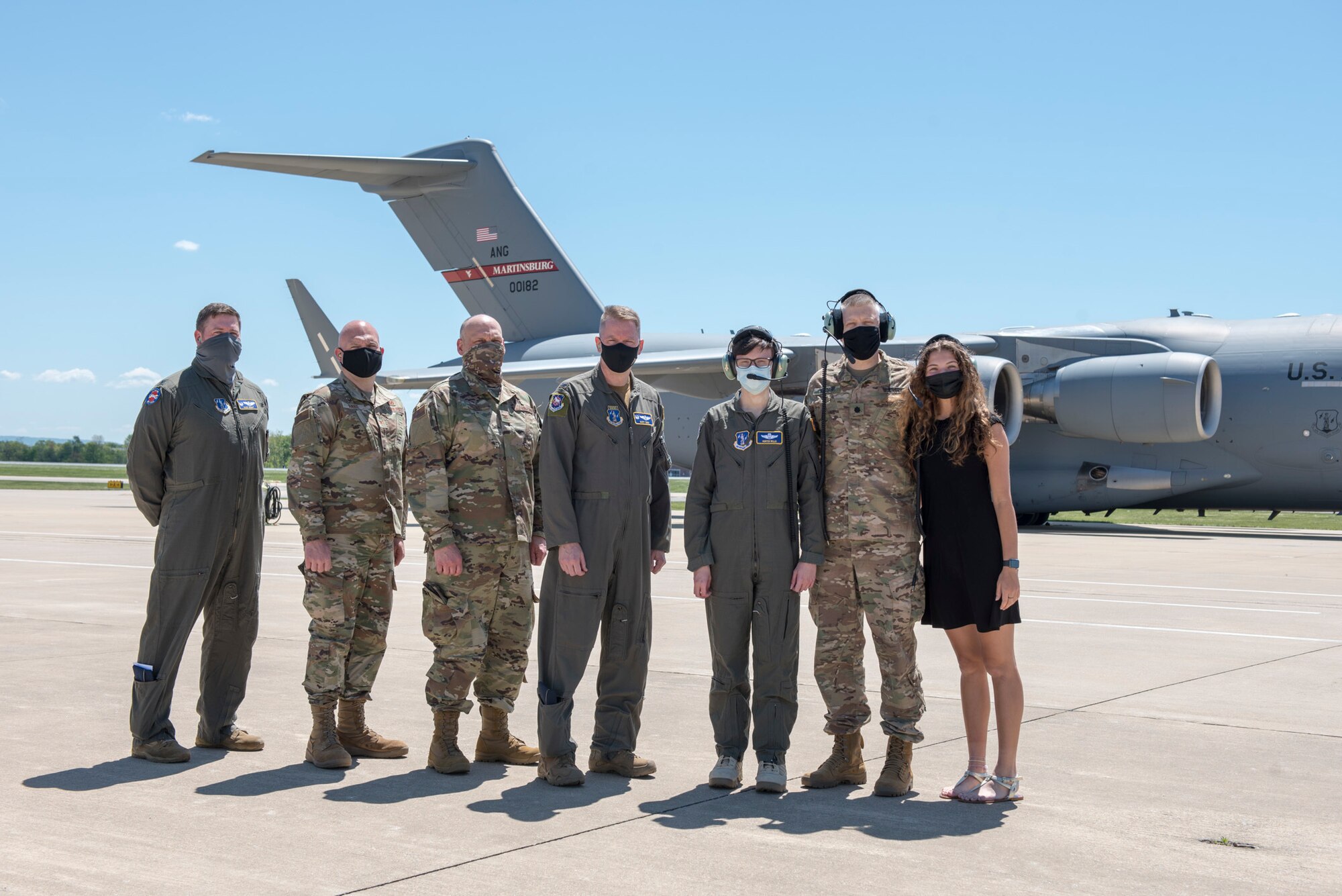 (From left to right) U.S. Air Force Maj. Randy Wright, Col. Bill Annie, Col. Rodney Neely, Col. Marty Timko, Hunter Willis, U.S. Army Lt. Col. Tom Willis and Penielle Willis gather on the flightline after returning from a training flight during a commander for the day event at the 167th Airlift Wing, Martinsburg, West Virginia, May 13, 2021. Hunter Willis, a local area resident diagnosed with a terminal illness, was invited to the 167th to serve as the wing commander for the day. After he was sworn in as commander, Willis was mission briefed, flown on a C-17 Globemaster III aircraft training mission and promoted his father, Tom Willis, to Lieutenant Colonel. (U.S. Air National Guard photo by Senior Airman Edward Michon).