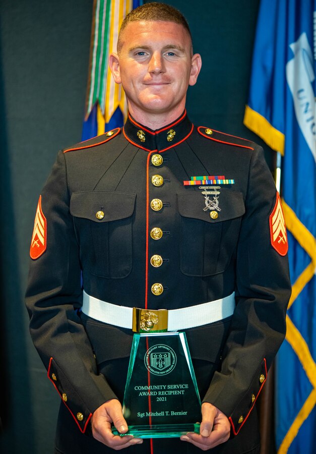 Sgt. Mitchell T. Bernier, a tuba player with Marine Forces Reserve Band, poses with the Community Service Award at the Armed Forces Day Award Ceremony at the World War II Museum in New Orleans on May 16, 2021. Bernier received the award for volunteering over 290 hours leading various group fitness activities at the Belle Chasse YMCA. (U.S. Marine Corps photo by Lance Cpl. Colby Bundy)