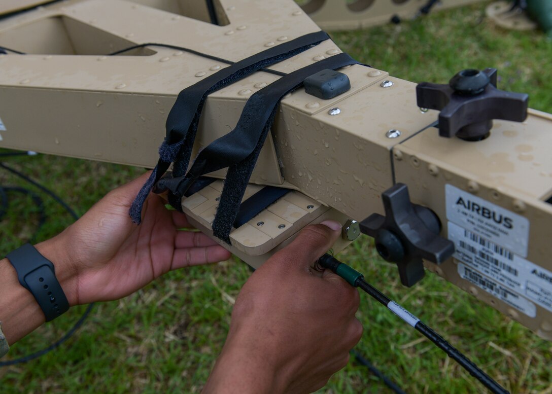 Airman 1st Class Laderran Lawston, 606th Air Control Squadron radio frequency technician, adjusts wires on an Airbus Ranger satellite communication terminal in use during Astral Knight 2021 (AK21) at Aviano Air Base, Italy, May 17, 2021. During AK21, the 606th ACS used the satellite to transmit radar and radio data to 606th ACS air controllers in Slovenia and Croatia, enabling them to control their airspace. (U.S. Air Force photo by Airman 1st Class Brooke Moeder)