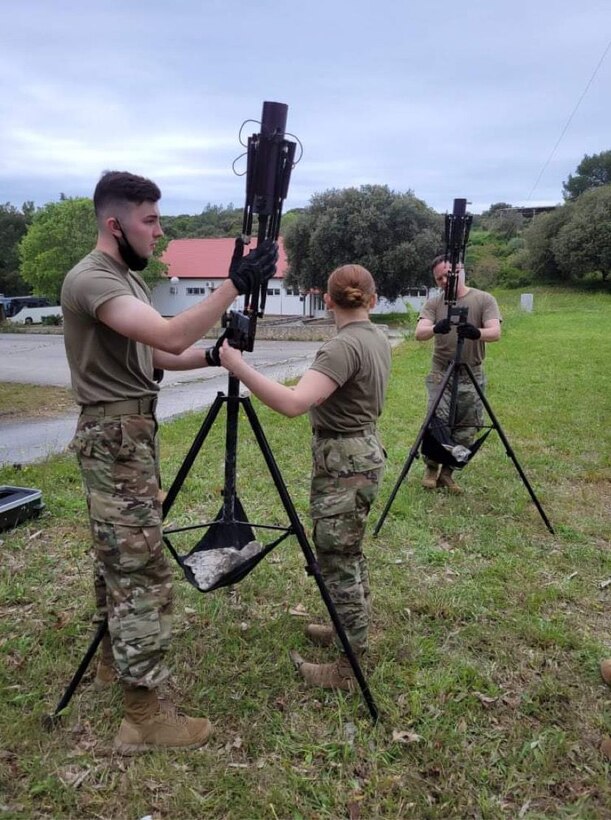 Senior Airman Timothy Carrier, left, Airman 1st Class Ashley Pilkerton, middle, 606th Air Control Squadron (ACS) surveillance technicians, and Tech. Sgt. Jeremiah Tatum, right, 606th ACS operations section chief, set up satellite communication antennas in support of Astral Knight 2021 in Mali Losinj, Croatia, May 18, 2021. The antennas allow the 606th ACS to communicate and transmit data with the 603rd Air Operations Center, the operational command and control center. (Courtesy Photo)
