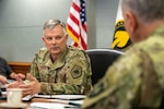 U.S. Air Force Gen. Glen D. VanHerck, commander of the North American Aerospace Defense Command and U.S. Northern Command, speaks to U.S. Army Brig. Gen. Shawn Satterfield, commander of U.S. Special Operations Command North.