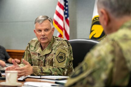 U.S. Air Force Gen. Glen D. VanHerck, commander of the North American Aerospace Defense Command and U.S. Northern Command, speaks to U.S. Army Brig. Gen. Shawn Satterfield, commander of U.S. Special Operations Command North.