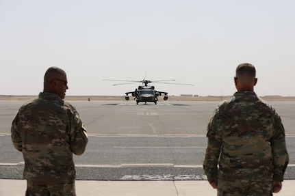 Task Force Phoenix Command Sgt. Maj. Refugio Rosas and Commander Col. Alan Gronewold await the arrival of visitors from Combined Joint Task Force - Operation Inherent Resolve on the flight line before a transfer of authority ceremony at Camp Buehring, Kuwait, May 16, 2021.