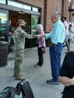 Soldier shakes man's hand