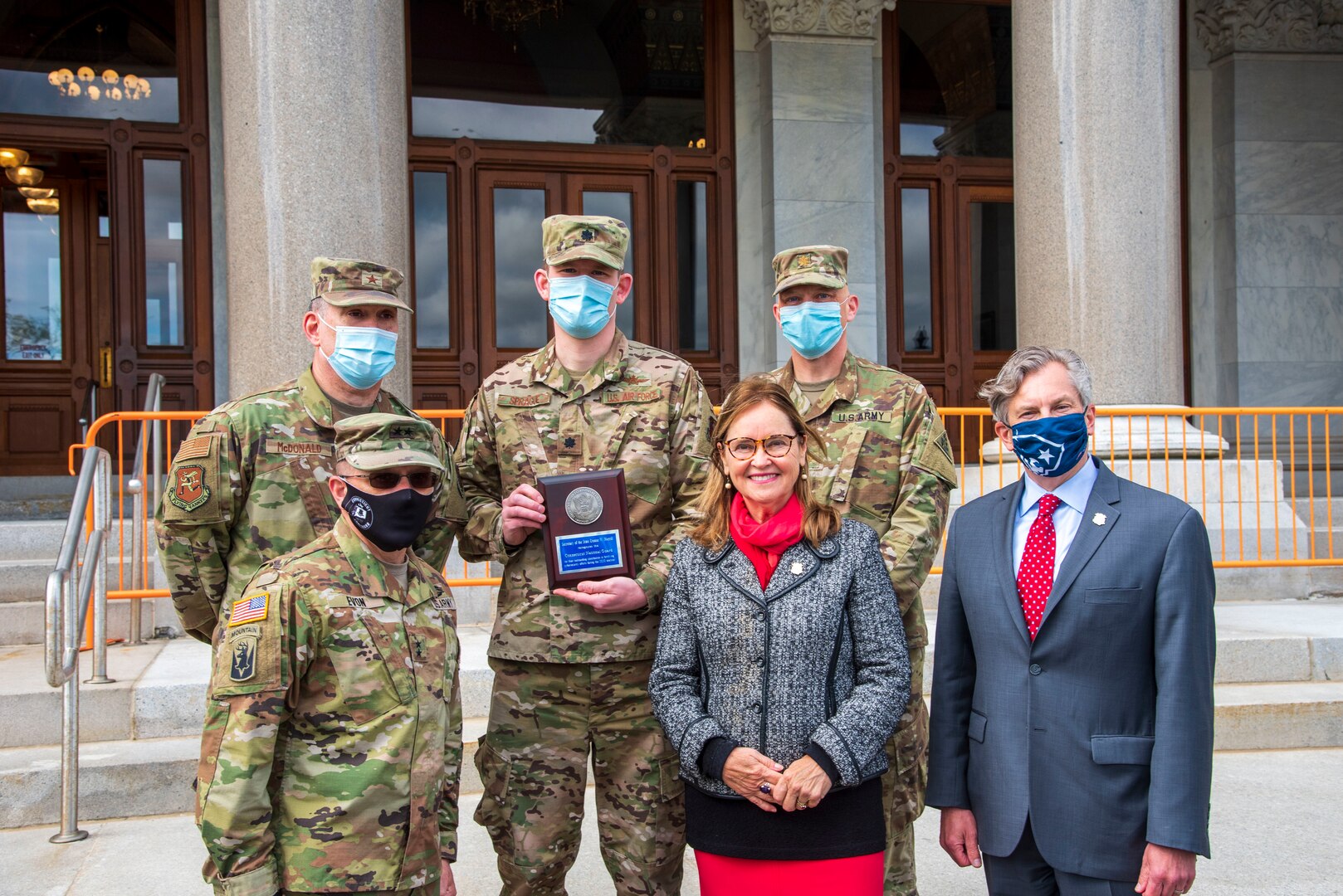 Maj. Gen. Francis Evon, adjutant general for the Connecticut National Guard, front left, and leaders of the Guard's Joint Cyber Response Team with Connecticut Secretary of State Denise Merrill and Deputy Secretary of State Scott Bates after the team received the National Association of Secretaries of State Medallion Award May 12, 2021, for fortifying cybersecurity ahead of the 2020 presidential election.