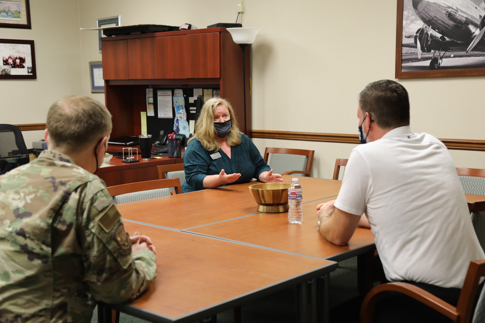 Mayor Andy Ryder, of the City of Lacey, Washington (right), and Col. Paul Skipworth, wing commander of the 446th Airlift Wing (left), speak with Kristi McCann, Director of Psychological Health for the 446th Airlift Wing, about resiliency and Airmen support services during a visit on May 10, 2021, at Joint Base Lewis-McChord, Washington.