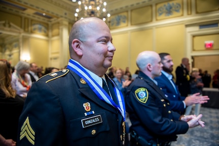 Oklahoma Army National Guard Sgt. Pedro Gonzales III stands with Oklahoma City Police Department Officer Zachary Barby and Tulsa Police Department Officer Aurash Zarkashan during an awards ceremony at the Oklahoma State Capitol in Oklahoma City, May 18, 2021. Oklahoma Governor Kevin Stitt presented Gonzales with the inaugural Oklahoma Medal of Valor, the state of Oklahoma’s highest award of honor presented to a member of a public safety agency or the public for heroic acts. (Oklahoma National Guard photo by Anthony Jones)
