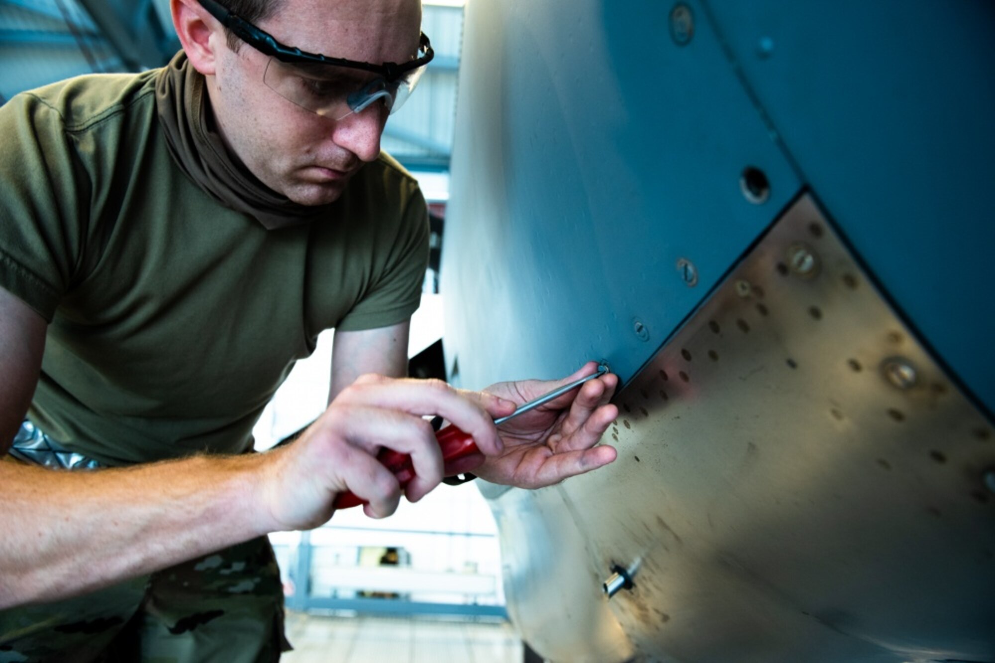 U.S. Air Force Tech. Sgt. Gregory Kolb, 86th Maintenance Squadron dock coordinator, secures the panel of a C-130J Super Hercules aircraft engine at Ramstein Air Base, Germany, Nov. 16, 2020. A seven-level technician must verify the correct installation of the engine panels before the aircraft is cleared to fly. (U.S. Air Force photo by Airman 1st Class Andrew J. Alvarado)