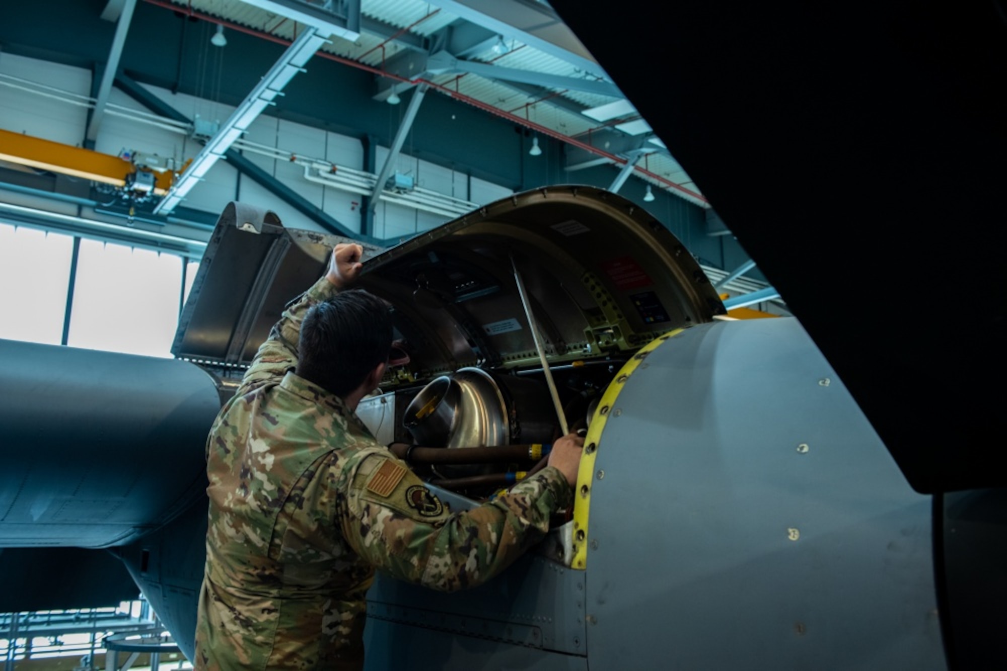 U.S. Air Force Airman 1st Class Ryan Hubbs, 86th Maintenance Squadron fuel cell technician, prepares to secure panels on a C-130J Super Hercules aircraft engine at Ramstein Air Base, Germany, Nov. 16, 2020. Repaneling is the process of securing panels which were previously removed for inspection and repair of an aircraft. (U.S. Air Force photo by Airman 1st Class Andrew J. Alvarado)