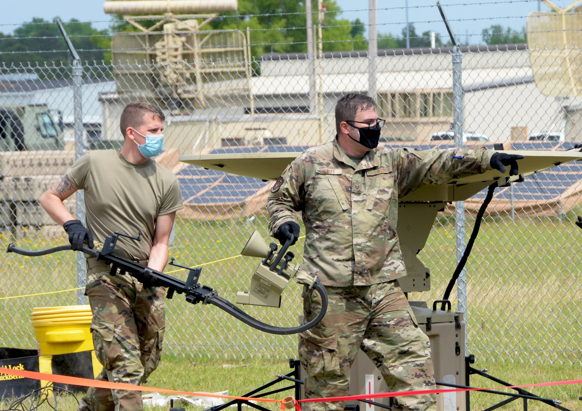 Senior Airman Joseph Faletto, 55th Combat Communications Squadron cyber systems operator, and Tech. Sgt. Benjamin Dawley, 35th Combat Communications Squadron cyber technician, carry equipment during the Total Force Expeditionary Communications Rodeo April 29, 2021, at Robins Air Force Base, Georgia. (U.S. Air Force photo by Tech. Sgt. Samantha Mathison)