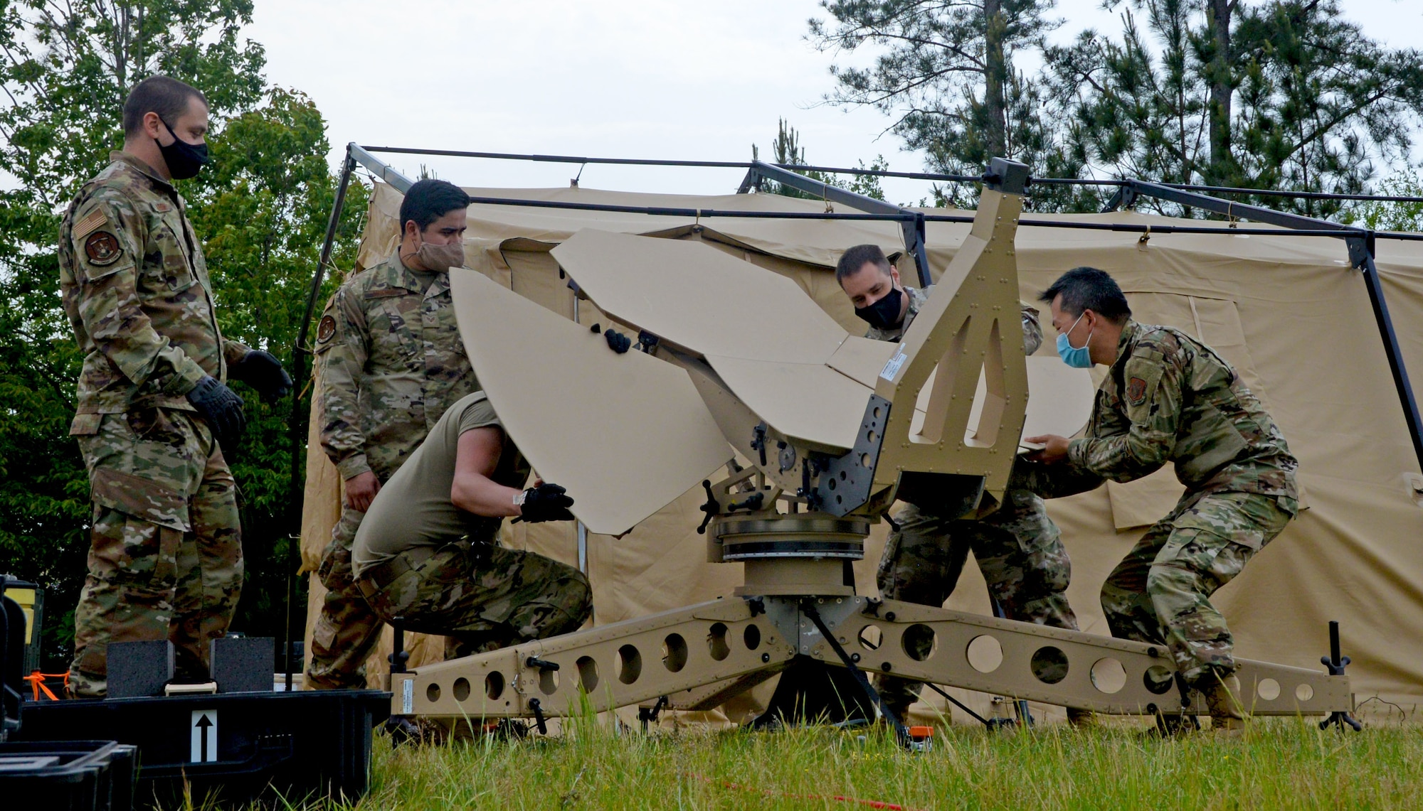 Combat communications Reserve Citizen Airmen dismantle a satellite April 29, 2021, at Robins Air Force Base, Georgia. The Airmen participated in the Total Force Expeditionary Communications Rodeo, which provided an opportunity for units in combat communications to gather in a joint environment and practice their skills in a simulated deployed location. (U.S. Air Force photo by Tech. Sgt. Samantha Mathison)