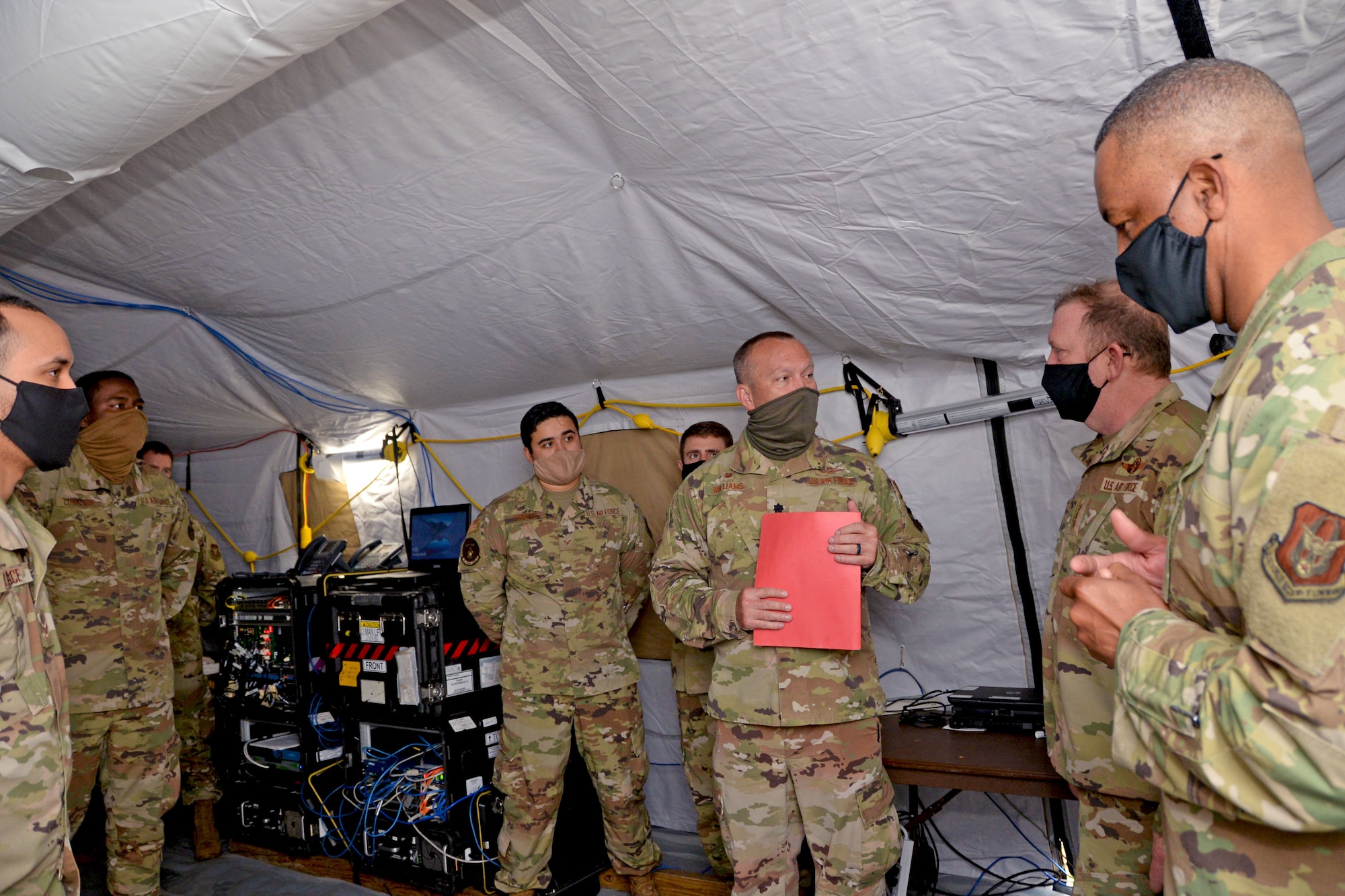 Lt. Gen. Richard Scobee, chief of the Air Force Reserve and commander of Air Force Reserve Command, and Chief Master Sgt. Timothy White Jr., senior enlisted advisor to the chief of the Air Force Reserve and command chief master Sergeant of AFRC, visit with combat communications Reserve Citizen Airmen of the 960th Cyberspace Wing, April 29, 2021, at Robins Air Force Base, Georgia. (U.S. Air Force photo by Tech. Sgt. Samantha Mathison)