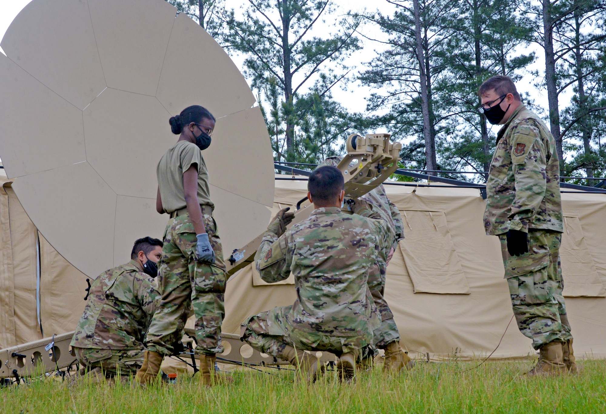 Combat communications Reserve Citizen Airmen dismantle a satellite April 29, 2021, at Robins Air Force Base, Georgia. The Airmen participated in the Total Force Expeditionary Communications Rodeo, which provided an opportunity for units in combat communications across the Air Force to practice their skills in a simulated deployed location. (U.S. Air Force photo by Tech. Sgt. Samantha Mathison)