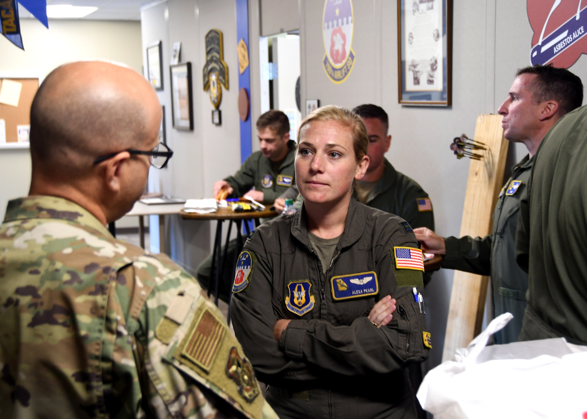 Capt. Alexa Pearl, 700th Airlift Squadron, speaks with Lt. Col. Antonio Ortiz-Guzman, 94th Airlift Wing chaplain, at Dobbins Air Reserve Base, Georgia, during a luncheon for Airmen.