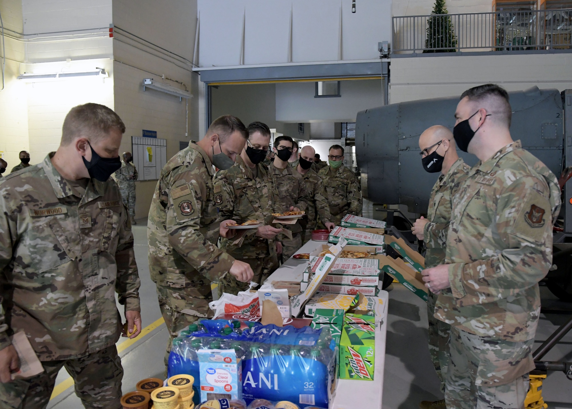 Lt. Col. Antonio Ortiz-Guzman, 94th Airlift Wing chaplain, and Senior Master Sgt. Anthony Devoile, 94th AW Religious Affairs superintendent, serve pizza to members of the 94th Maintenance Squadron during a luncheon on April 15, 2021, at Dobbins Air Reserve Base, Ga.