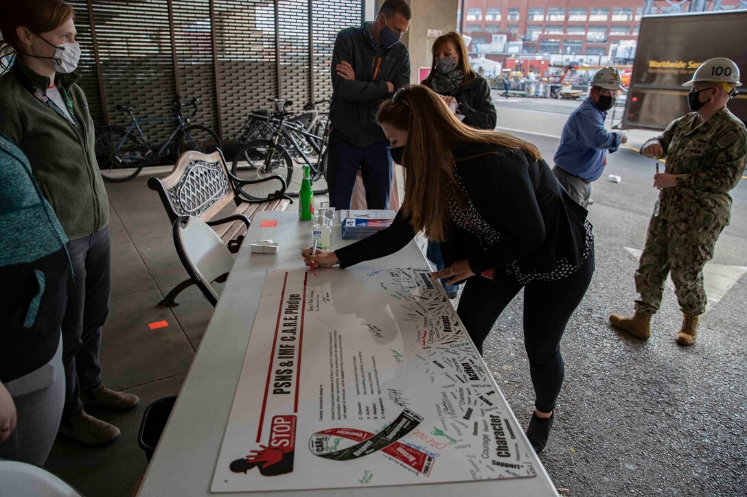Puget Sound Naval Shipyard & Intermediate Maintenance Facility leaders and employees signed C.A.R.E. pledges and banners during two events May 18, 2021, at locations throughout the shipyard in Bremerton, Washington.
