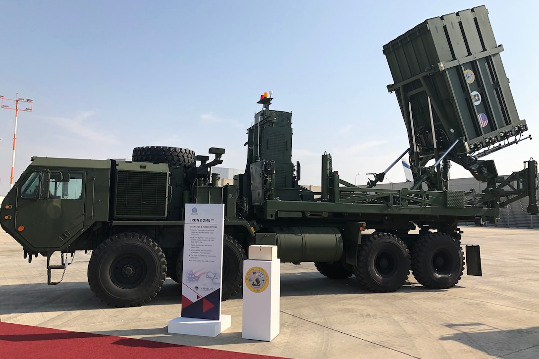 Iron Dome missile system is on display on a tarmac.