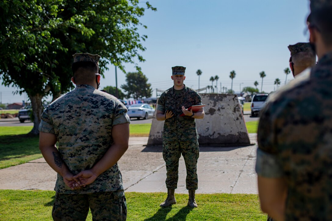 U.S. Marine Corps Cpl. Skylar Jacobson, an administration specialist with Headquarters and Headquarters Squadron (H&HS), re-enlists during a ceremony aboard Marine Corps Air Station Yuma on May 14, 2021.