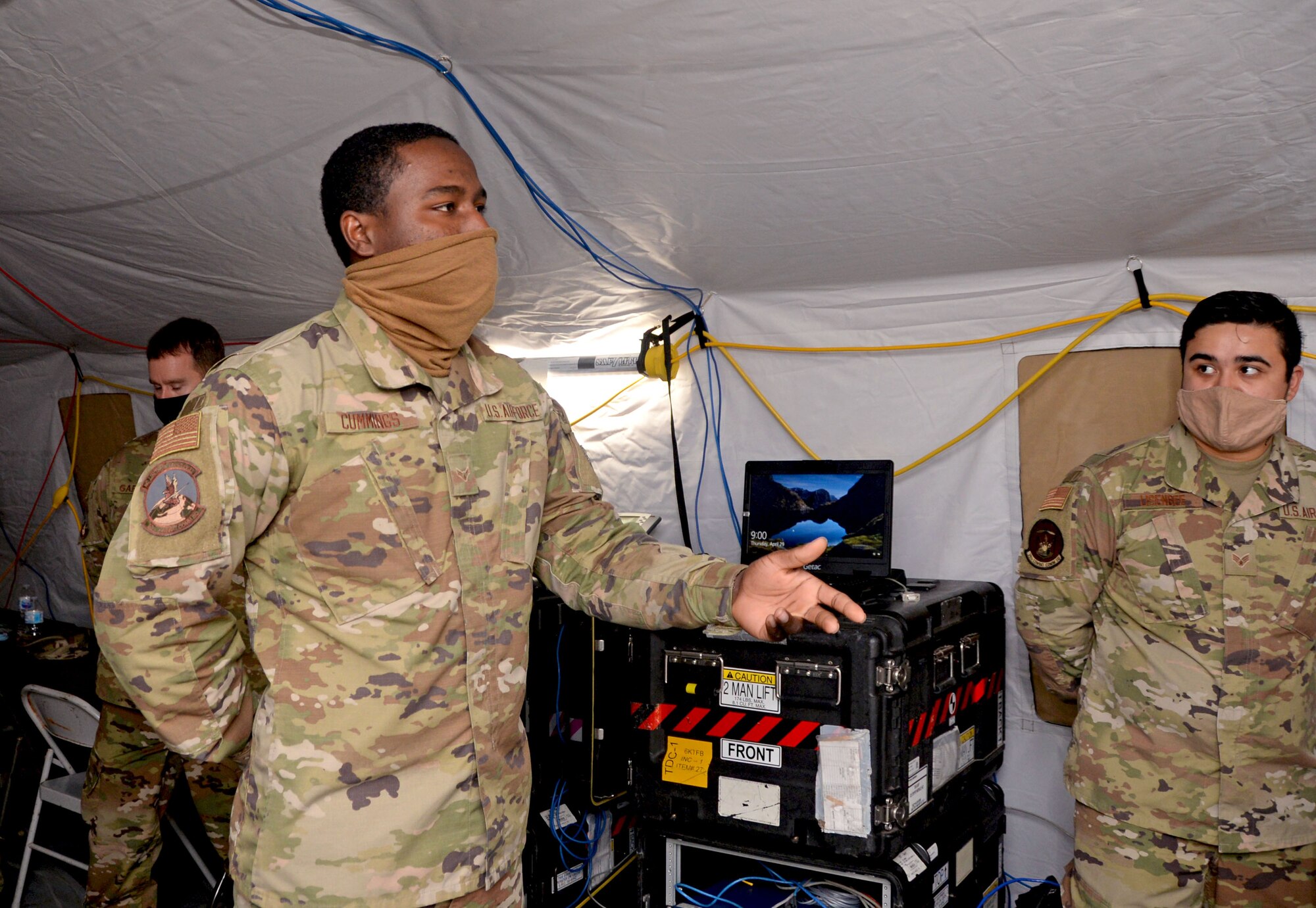 Airman First Class Marquel Cummings, 55th CBCS cyber transport technician, delivers a briefing to Air Force Reserve Command leadership April 29, 2021, at Robins Air Force Base, Georgia. Lt. Gen. Richard Scobee, chief of the Air Force Reserve and commander of the AFRC, recognized Cummings with a coin for excellence after his briefing. (U.S. Air Force photo by Tech. Sgt. Samantha Mathison)